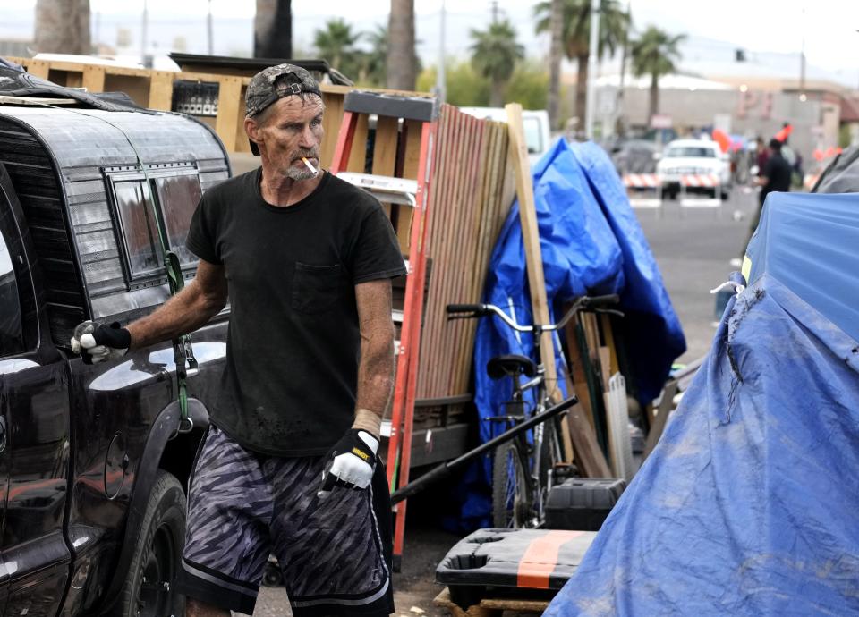 Brian Patrick packs up his belongings as mandatory removal of "The Zone," a homeless camp in Phoenix, on May 10, 2023.