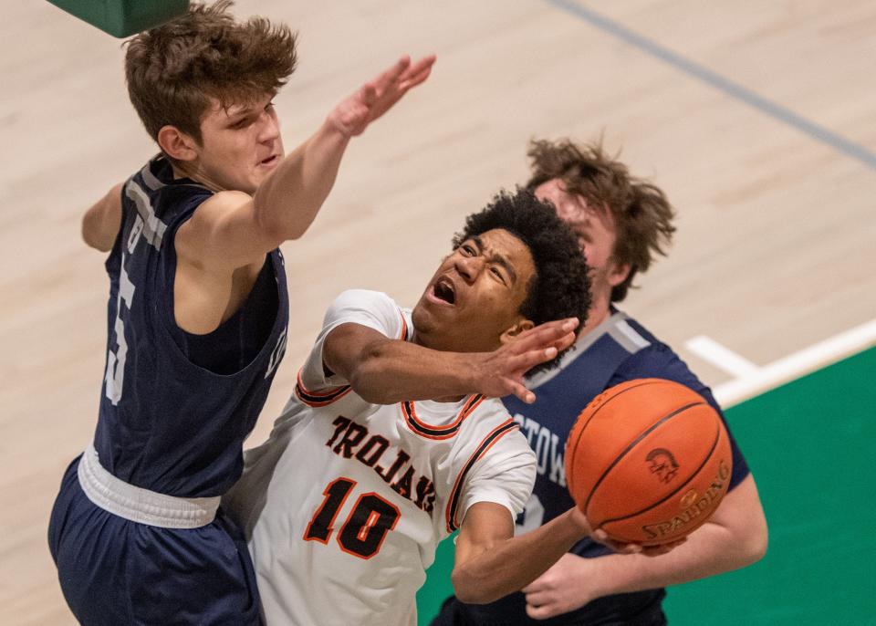York Suburban’s Mekhi Rhoades (10) tries to shoot around the block attempt by Dallastown’s Chase McLane in Hoops for Harmony at York County Tech on Saturday, Jan. 13, 2024. Dallastown won 60-52.