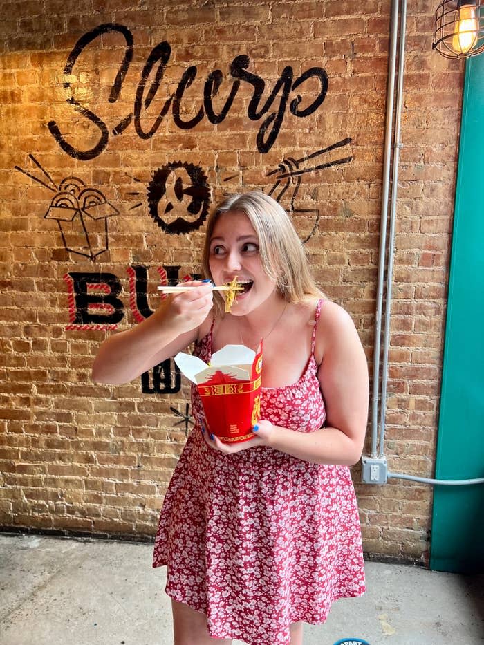 A woman eating Chinese food