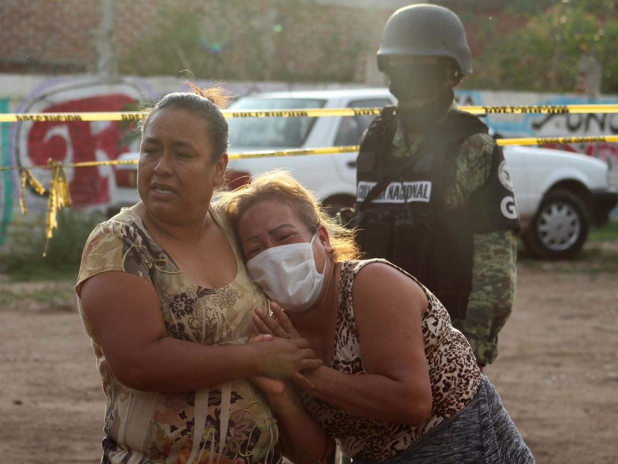 Women react outside a drug rehabilitation facility where assailants killed several people in Mexico: REUTERS