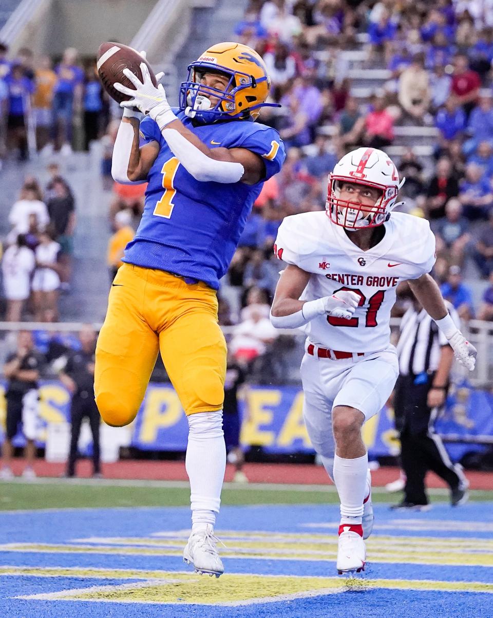 Carmel Greyhounds Desmond Duffy (1) catches the ball in the end zone against Center Grove Trojans Gavin Oakes (21) on Friday, September 3, 2021, at Carmel High School in Carmel. Center Grove Trojans lead at the half against the Carmel Greyhounds, 10-7. 