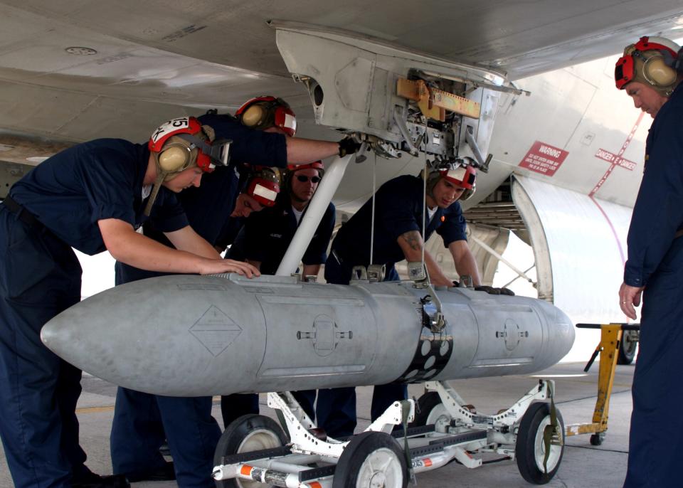 Aviation Ordnancemen download an AN/AWW-13 Advanced Data Link pod from a weapons pylon on a P-3C Orion in Okinawa, Japan. The AN/AWW-13 Advanced Data Link allows the operator to select an aim point for weapon impact and provides the only currently available link between munition seekers and humans. The pod is typically used by the Standoff Land Attack Missile-Expanded Response (SLAM-ER) missile. (U.S. Navy photo by Photographer's Mate 3rd Class Shannon R. Smith)