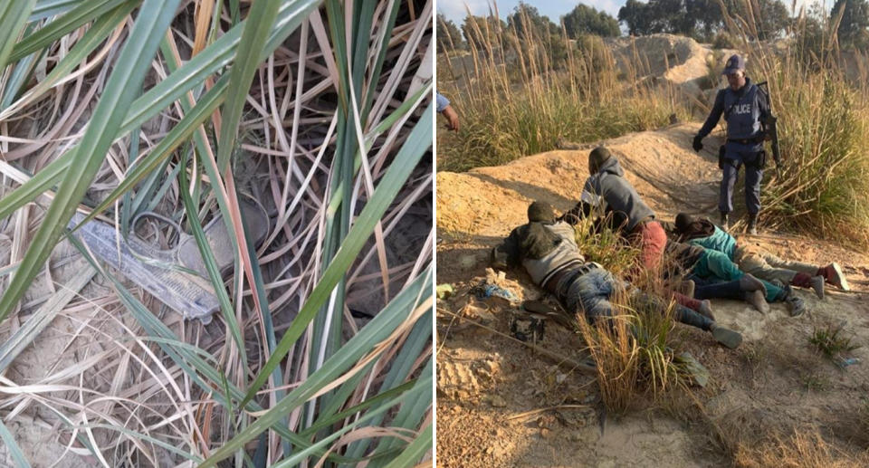 Four men are seen on the ground near a police officer and a gun hidden in some bushes. 