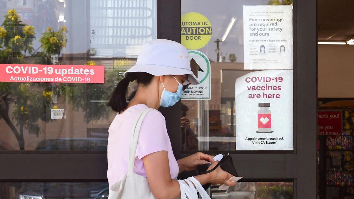 A woman enters a CVS drugstore