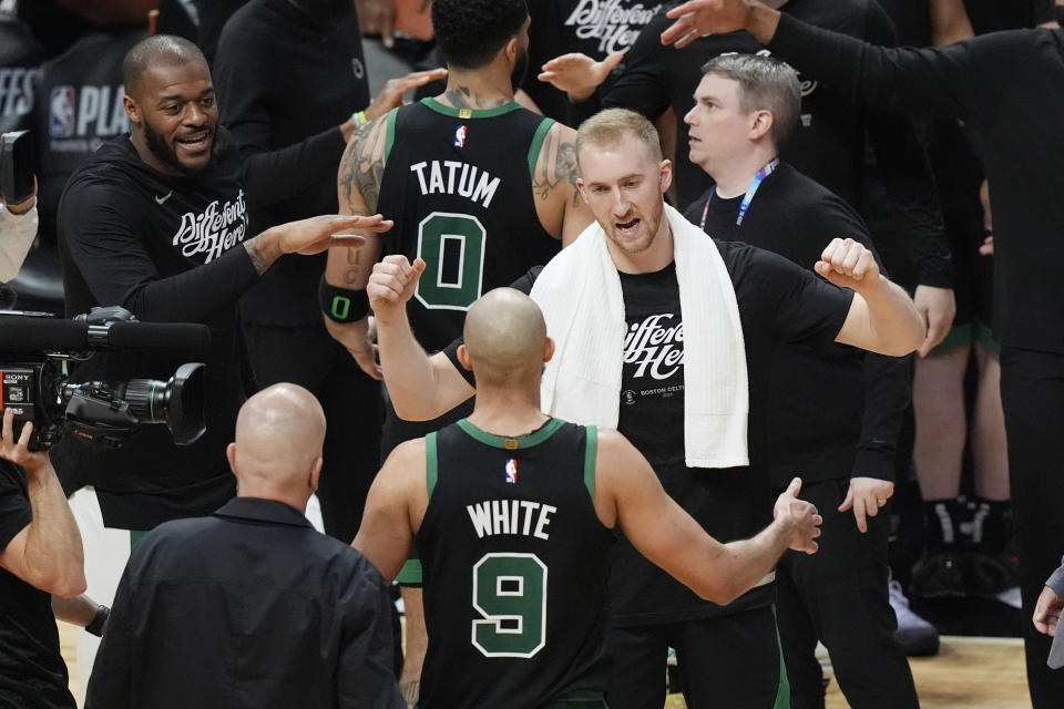 The Boston Celtics celebrate at the end of of Game 4 of an NBA basketball first-round playoff series against the Miami Heat, Monday, April 29, 2024, in Miami. (AP Photo/Marta Lavandier)