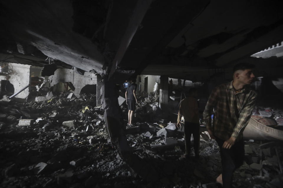 Palestinians search for survivors after an Israeli airstrike on a residential building of the abo al Hanood family in Rafah refugee camp, southern Gaza Strip, Wednesday, April 17, 2024. (AP Photo/Ismael Abu Dayyah)