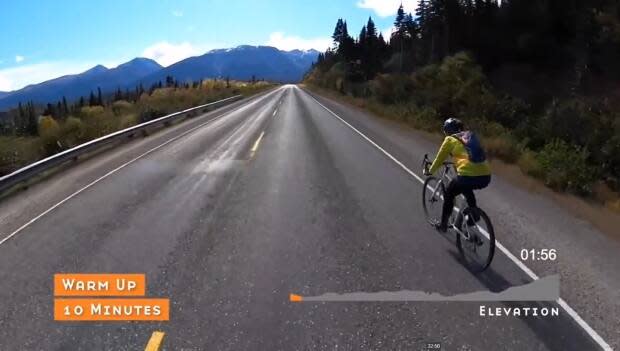 A screen capture from a Yukon Spin video shows a cyclist heading out on the South Klondike Highway. (Yukon Transportation Museum - image credit)