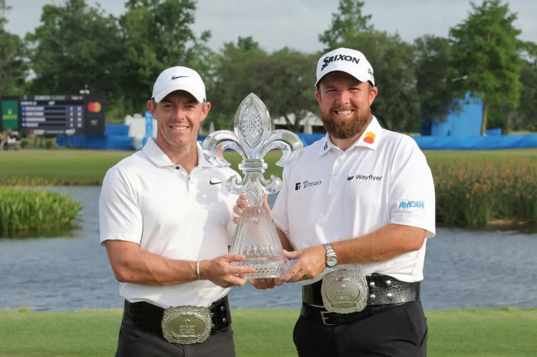 Rory McIlroy and Shane Lowry pose with the trophy after winning the Zurich Classic of New Orleans at TPC Louisiana on Sunday. (Jonathan Bachman)