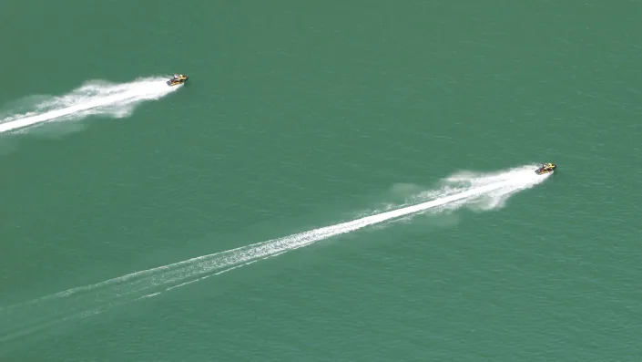 Jet skis move through Red Canyon on Friday, Aug. 5, 2022, in Flaming Gorge National Recreation Area, in the northeastern corner of Utah. A boating and fishing paradise on the Utah-Wyoming line, Flaming Gorge Reservoir is beginning to feel the effects of the two-decade megadrought gripping the southwestern U.S. (AP Photo/Rick Bowmer)