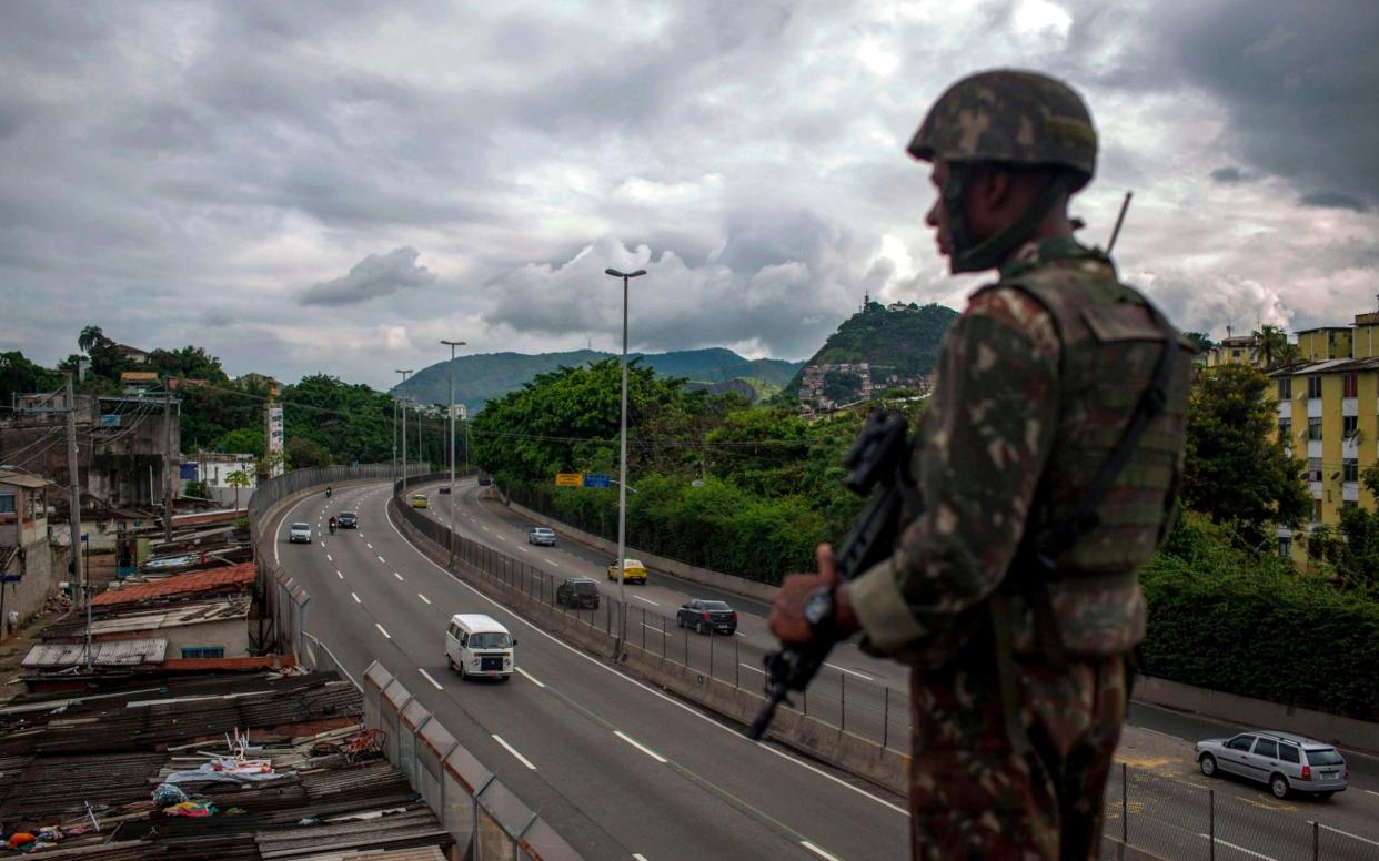 A Brazilian Army soldier stands guard over the