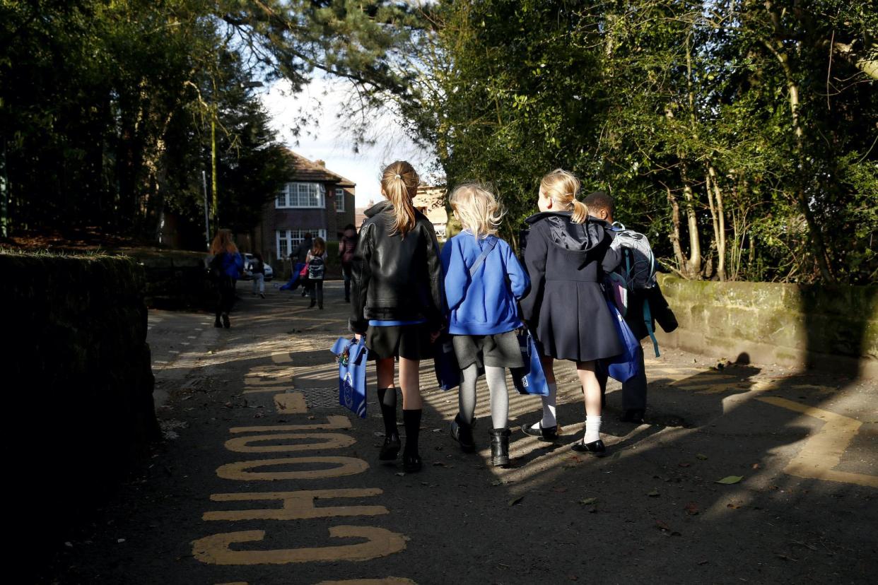 Children walk home from Altrincham C.E. aided primary school after the government's policy to close all schools from today due to the coronavirus pandemic on March 20, 2020 in Altrincham, United Kingdom: Clive Brunskill/Getty Images