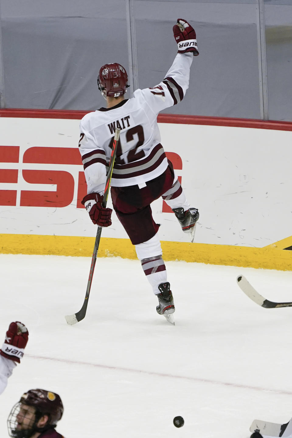 Massachusetts' Garrett Wait (12) celebrates after scoring against Minnesota Duluth during overtime in an NCAA men's Frozen Four hockey semifinal in Pittsburgh, early Friday, April 9, 2021. Massachusetts won 3-2 and will face St. Cloud State in the championship game Saturday. (AP Photo/Keith Srakocic)