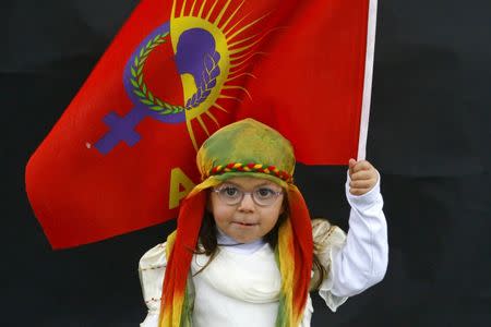 A Kurdish girl poses for a picture as she arrives for a gathering celebrating Newroz in Diyarbakir March 21, 2015. REUTERS/Umit Bektas