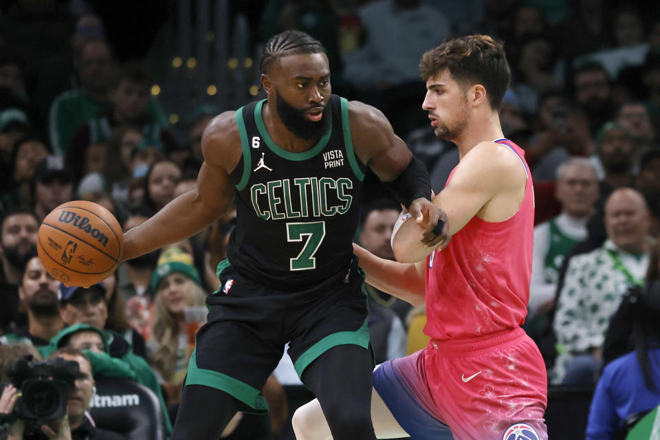 Boston Celtics guard Jaylen Brown (7) drives against Washington Wizards forward Deni Avdija (9) during the first half of an NBA basketball game Sunday, Nov. 27, 2022, in Boston. (AP Photo/Mary Schwalm)