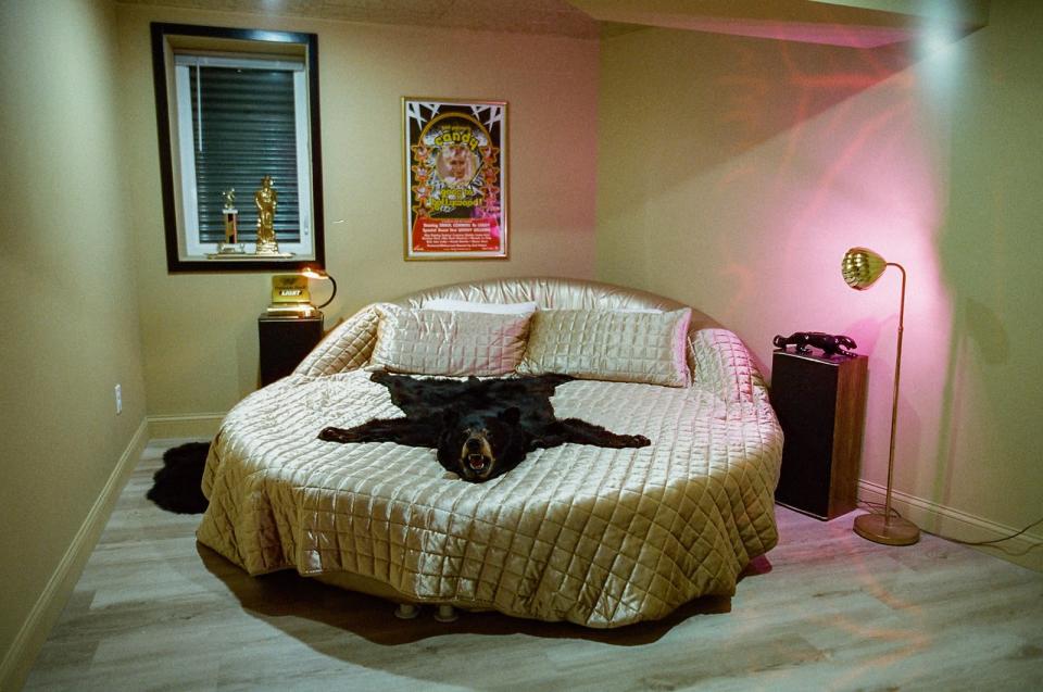 Bachelorette parties may be a key audience for Grandpa&#x002019;s Pool House, but Eva tried to balance out the home with a wilderness room and a gold fantasy suite. Seventies-era Burt Reynolds laying across this bed would complete the vibe.