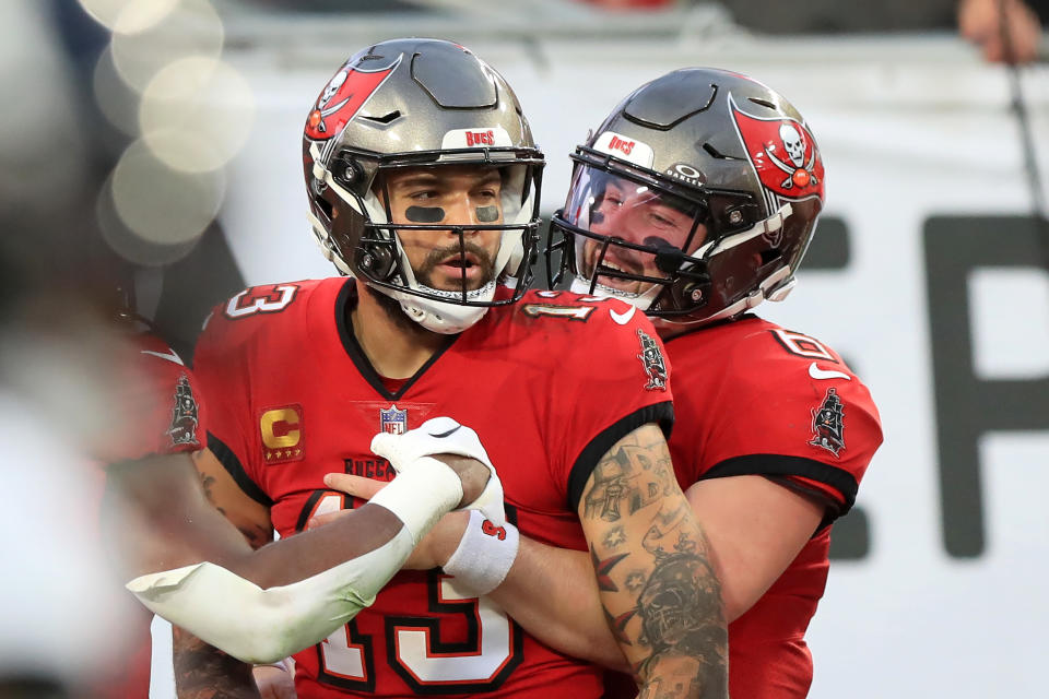 TAMPA, FL - DECEMBER 24: Tampa Bay Buccaneers Wide Receiver Mike Evans (13) scores a touchdown and Quarterback Baker Mayfield (6) hugs Evans during the regular season game between the Jacksonville Jaguars and the Tampa Bay Buccaneers on December 24, 2023 at Raymond James Stadium in Tampa, Florida. (Photo by Cliff Welch/Icon Sportswire via Getty Images)