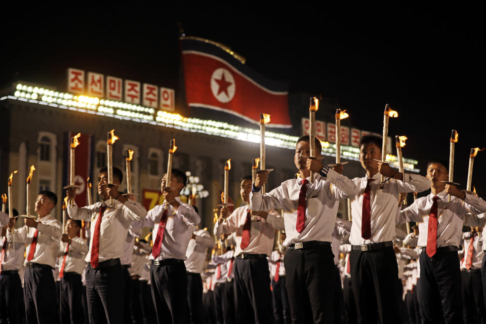 North Korean youths holding torches march during a torch light march at the Kim Il Sung Square in conjunction with the 70th anniversary of North Korea's founding day in Pyongyang, North Korea, Monday, Sept. 10, 2018. Tens of thousands of North Koreans rallied in the square in the final major event of the country's 70th anniversary, an elaborate celebration that was focused on Korean unity and economic development and that deliberately downplayed the missiles and nuclear weapons that brought the North to the brink of conflict with the United States just one year ago. (AP Photo/Kin Cheung)