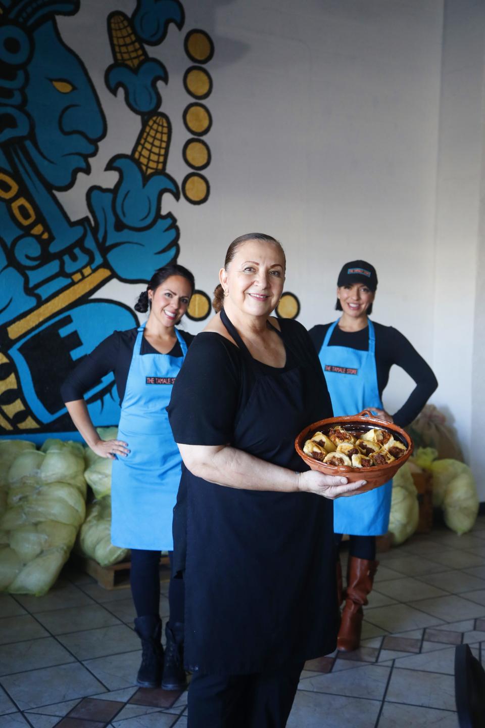 Martha Castillo (center) stands with her famous tamales and daughters Maria Stanzak (L) and Pauline Pimienta (R) at the Tamale Store in Phoenix, Ariz. on November 26, 2018.