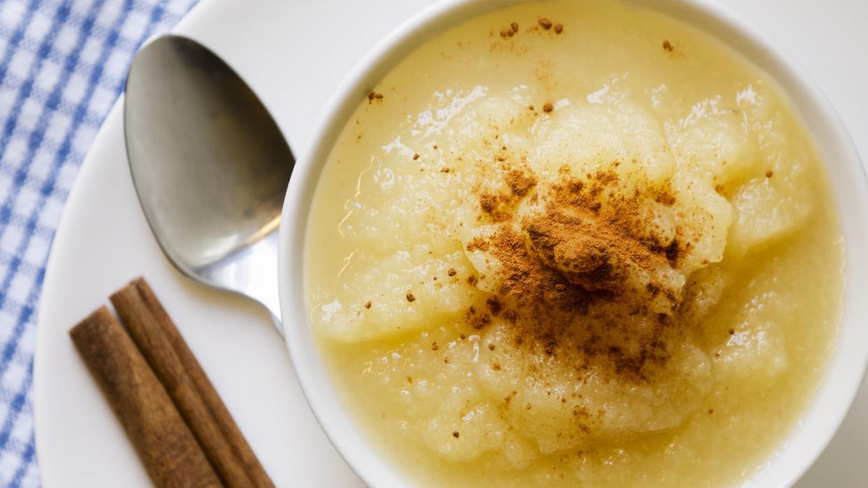 applesauce with cinnamon in a white bowl viewed from above