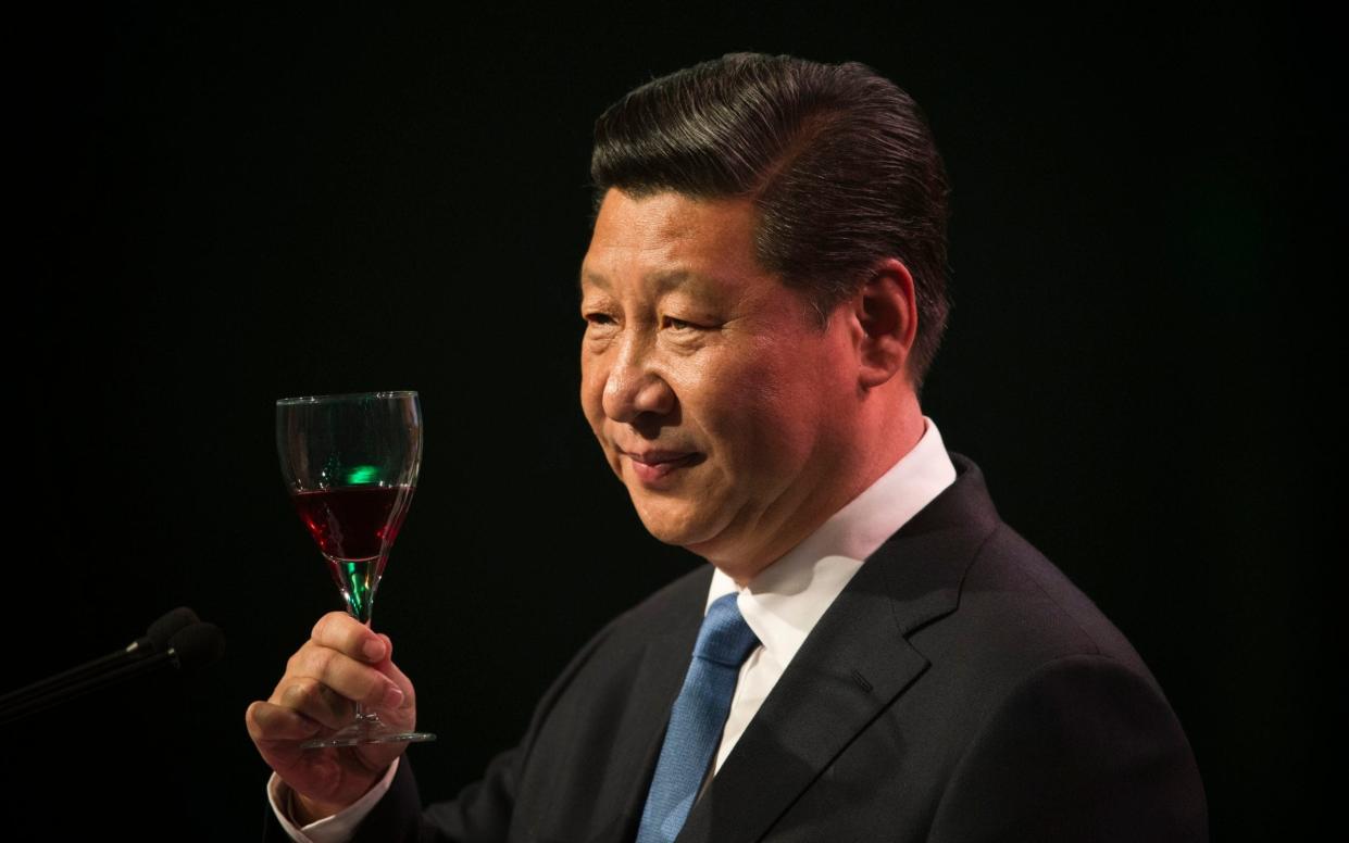 Chinese President Xi Jinping raises his glass during a toast at a talk in New Zealand in 2014 - Getty Images AsiaPac