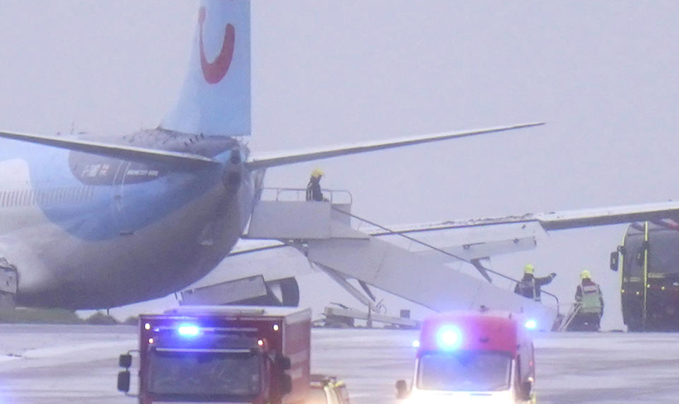 Emergency services at the scene after a passenger plane which came off the runway while landing in windy conditions at Leeds Bradford Airport, Leeds, England, Friday, Oct. 20, 2023. (Danny Lawson/PA via AP)