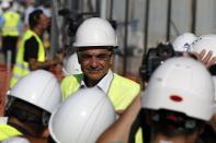 Greece's Prime Minister Kyriakos Mitsotakis wearing a helmet and plastic glasses stands at the old airport in Athens, Friday, July 3, 2020. Mitsotakis inaugurated the start of construction work on a long-delayed major development project at the prime seaside site of the old Athens airport. The development of the 620-hectare (1,500-acre) Hellenikon site was a key element of the privatization drive that was part of Greece's international bailouts. (AP Photo/Thanassis Stavrakis)