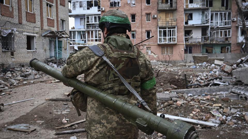 A Ukrainian soldier carries a portable anti-aircraft missile system in the area of the heaviest battles with the Russian invaders in Bakhmut, within the country's Donetsk region, March 15. (Roman Chop/AP)