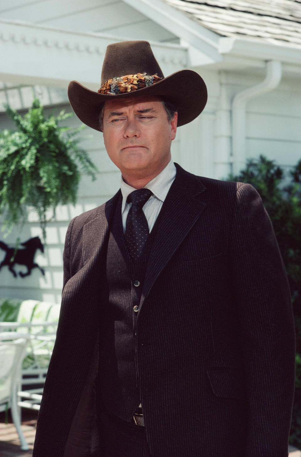 A promotional still from the American television series 'Dallas' shows Larry Hagman (as John Ross 'J.R.' Ewing, Jr.), dressed in a darkcolored three-piece suit and matching Stetson, May 1983. (Photo by CBS Photo Archive/Getty Images) 