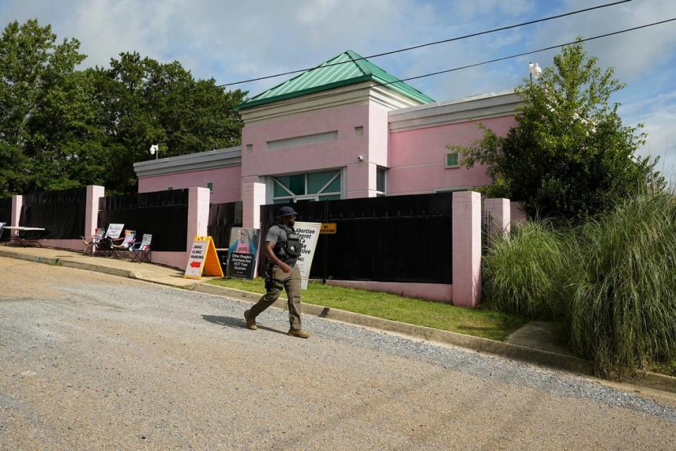 A security officer walks past the front of the Jackson Women’s Health Organization clinic in Jackson, Miss., Sunday, July 3, 2022. The medical facility was open for three hours before anti-abortion protesters arrived. The clinic is the only facility that performs abortions in the state. On June 24, the U.S. Supreme Court overturned Roe v. Wade, ending constitutional protections for abortion. However, a Mississippi judge has set a hearing for Tuesday, in a lawsuit by the state’s only abortion clinic that seeks to block a law that would ban most abortions. (AP Photo/Rogelio V. Solis)