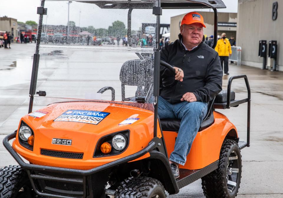 Chip Ganassi Racing owner Chip Ganassi drives through Gasoline Alley on a wet and rainy Friday, May 28, 2021, during Carb Day at Indianapolis Motor Speedway.