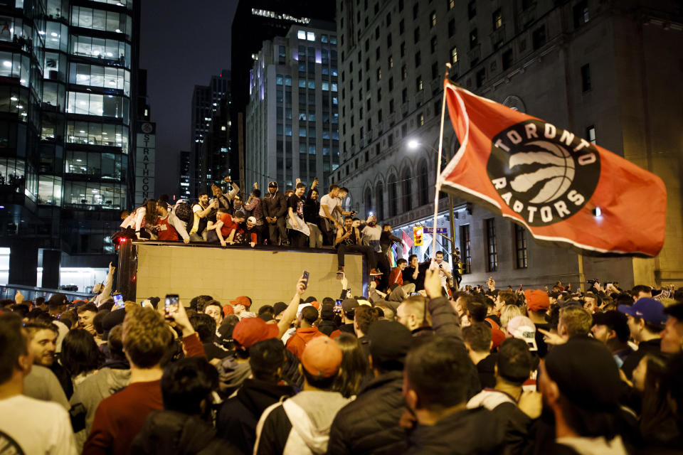 TORONTO, ON - JUNE 13: Fans celebrate a victory over the Golden State Warriors in game six of the NBA Finals on June 13, 2019 in Toronto, Canada. (Photo by Cole Burston/Getty Images)