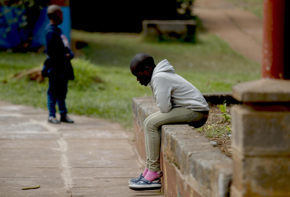 A child sits outside a classroom at the Nyumbani Children's Home in Nairobi, Kenya Tuesday, Aug. 15, 2023. The orphanage, which is heavily reliant on foreign donations, cares for over 100 children with HIV whose parents died of the disease and provides them with housing, care, and PEPFAR supplied anti-retroviral drugs. A U.S. foreign aid program that officials say has saved 25 million lives in Africa and elsewhere is being threatened by some Republicans who fear program funding might go to organizations that promote abortion. (AP Photo/Brian Inganga)