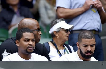 Rapper Drake (R) watch the match between Serena Williams and Venus Williams of the U.S.A. at the Wimbledon Tennis Championships in London, July 6, 2015. REUTERS/Toby Melville