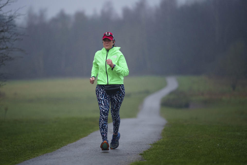 Ultra runner Helen Ryvar passes through Alyn Waters Country Park in Wrexham during running a half marathon in Wrexham, Wales, Wednesday, March 20, 2024. Helen who took up running in 2020 just before lockdown completes her daily half marathon early so as to fit in a full time job and being a single parent to 3 children. (AP Photo/Jon Super)