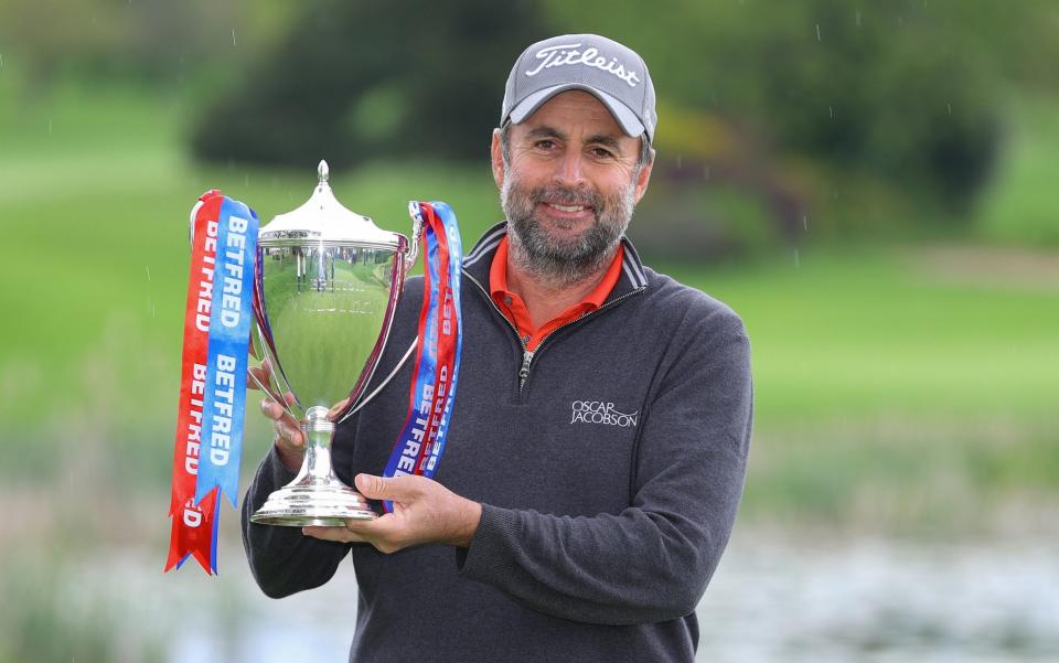 That winning feeling for Richard Bland as he finally gets his hands on a trophy - GETTY IMAGES