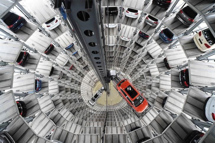 A VW Golf VII car and a VW Passat are loaded in a delivery tower at the plant of German carmaker Volkswagen in Wolfsburg