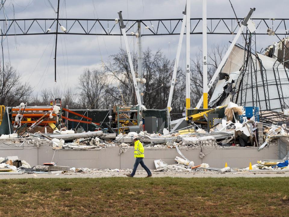 A responder walks past the wreckage at the site of a roof collapse at an Amazon distribution center after a tornado hits Edwardsville, in Illinois, U.S. December 11, 2021 (REUTERS)