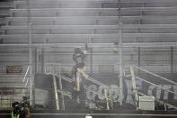 Noah Gragson (9) celebrates by climbing the fence in front of empty stands after winning a NASCAR Xfinity Series auto race at Bristol Motor Speedway Monday, June 1, 2020, in Bristol, Tenn. (AP Photo/Mark Humphrey)