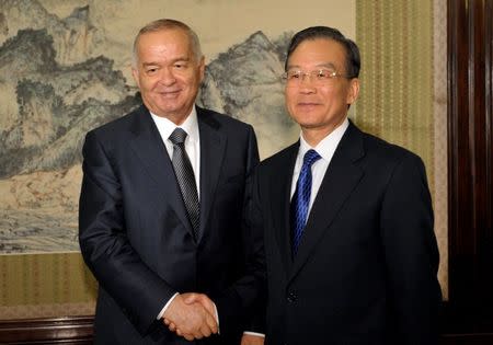 FILE PHOTO - Uzbek President Islam Karimov (L) shakes hands with Chinese Premier Wen Jiabao during a meeting at Zhongnanhai in Beijing April 20, 2011. REUTERS/Kota Kyogoku/Pool/File Photo