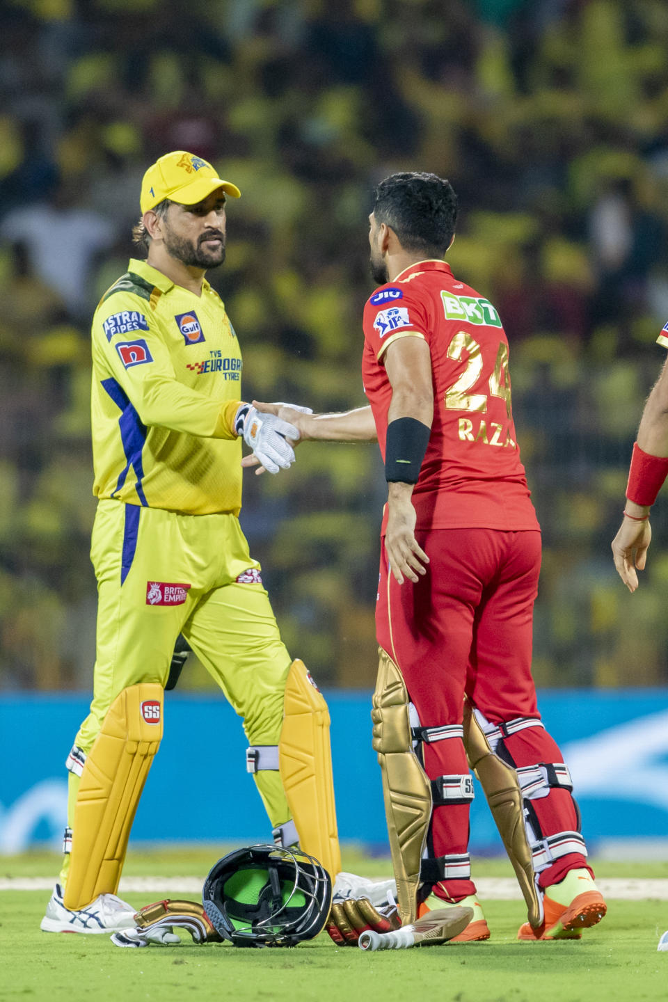 Sikandar Raza of Punjab Kings, right shakes hands with MS Dhoni of Chennai Super Kings after winning the Indian Premier League cricket match between Chennai Super Kings and Punjab Kings in Chennai, India, Sunday, April 30, 2023. (AP Photo/ R. Parthibhan)