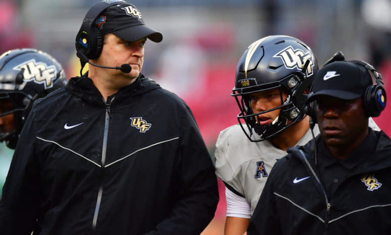 UCF coach Josh Heupel talks to Dillon Gabriel during bowl game.