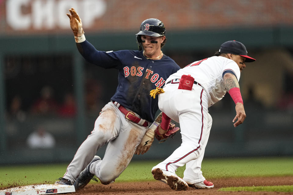 Boston Red Sox' Jarren Duran (16) steals second base as Atlanta Braves shortstop Orlando Arcia (11) applies the late tag in the second inning of a baseball game Tuesday, May 9, 2023 in Atlanta. (AP Photo/John Bazemore)