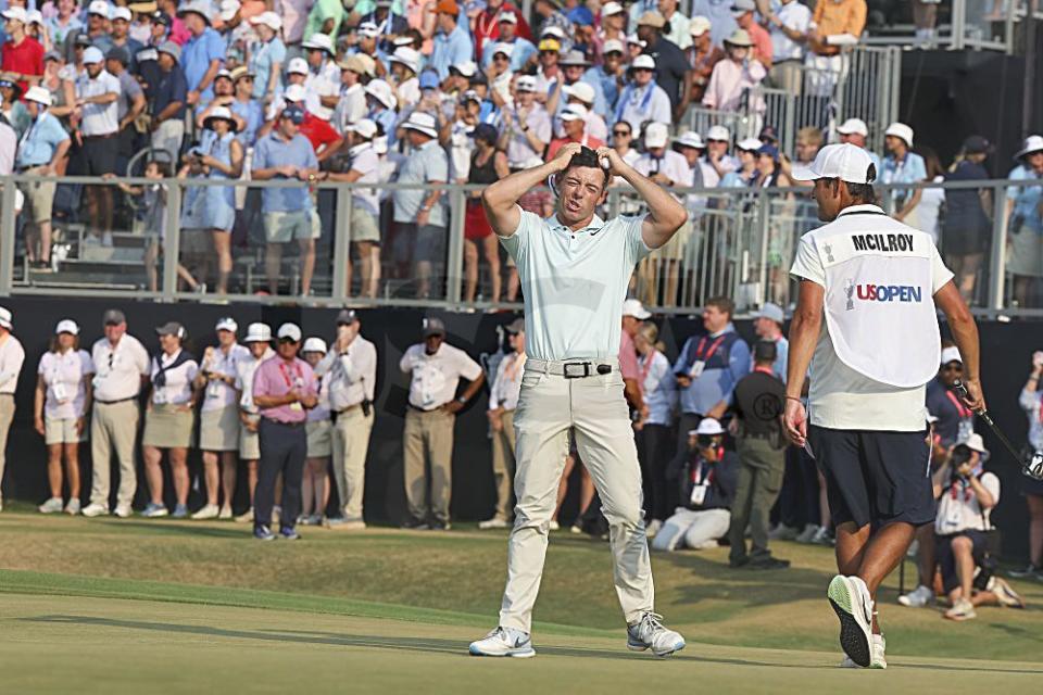 A dejected Rory McIlroy reacts on the 18th green