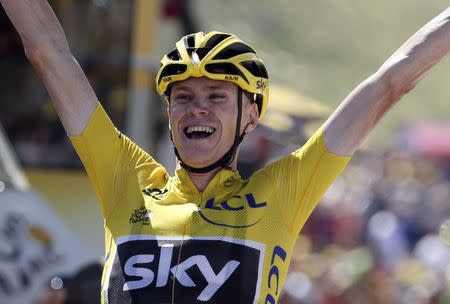 Team Sky rider Chris Froome of Britain, race leader's yellow jersey, celebrates as he crosses the finish line to win the 167-km (103.7 miles) 10th stage of the 102nd Tour de France cycling race from Tarbes to La Pierre-Saint -Martin, France, July 14, 2015. REUTERS/Stefano Rellandini