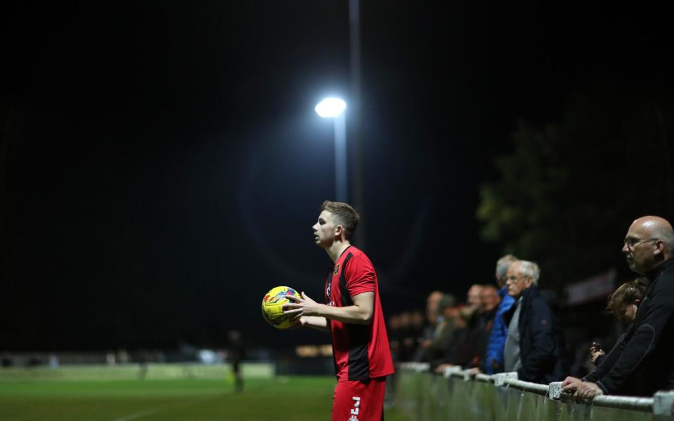 Danny King of Winchester prepares to throw in the ball as fans look on during the FA Cup First Qualifying Round match between Winchester City and Clevedon Town  - GETTY IMAGES