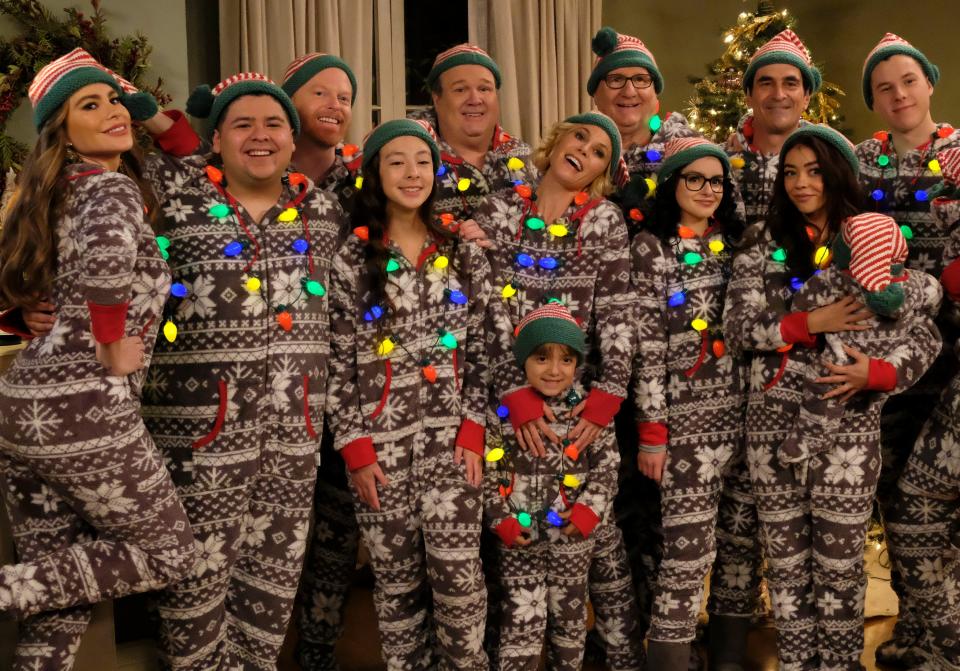 they're all dressed in christmas onesies with lights around them
