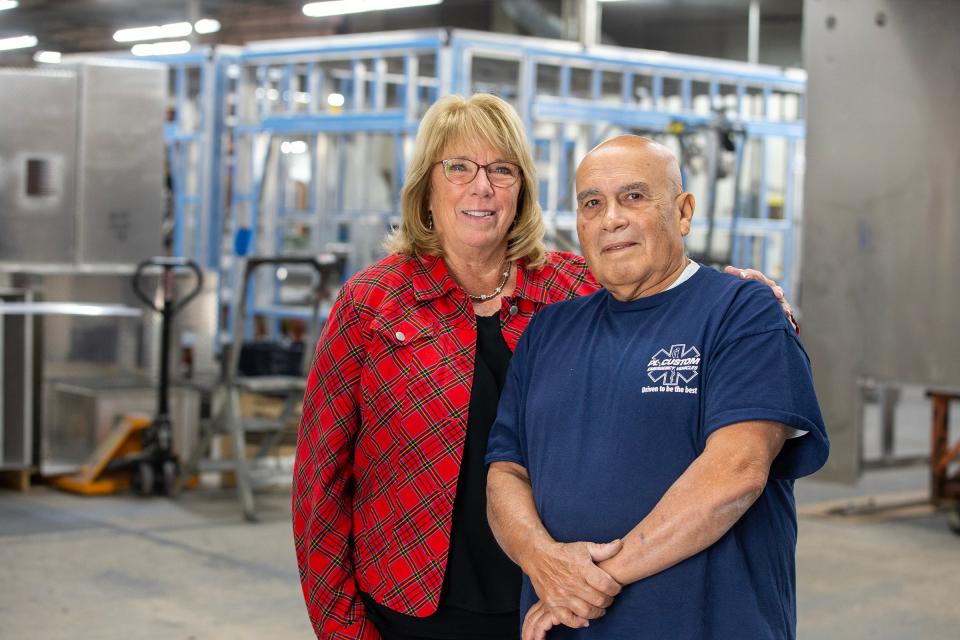 Mike Borrero, a welder who is celebrating 50 years of employment at P L Custom Emergency Vehicles, stands with Deborah Smock Thomson at P L Custom Emergency Vehicles in Wall, NJ Tuesday, October 10, 2023.