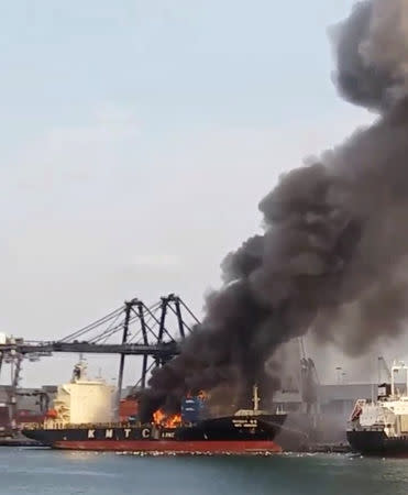 Smoke rises from a KMTC cargo ship after it caught on fire at the Laem Chabang port, Chonburi province, Thailand May 25, 2019 in this still image take from social media video. Mbah Ambyah via REUTERS