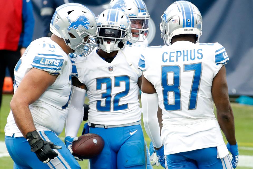 Running back D'Andre Swift (32) of the Detroit Lions celebrates with teammates after rushing for a touchdown over the Tennessee Titans during the second quarter of the game  at Nissan Stadium on Dec. 20, 2020 in Nashville, Tennessee.