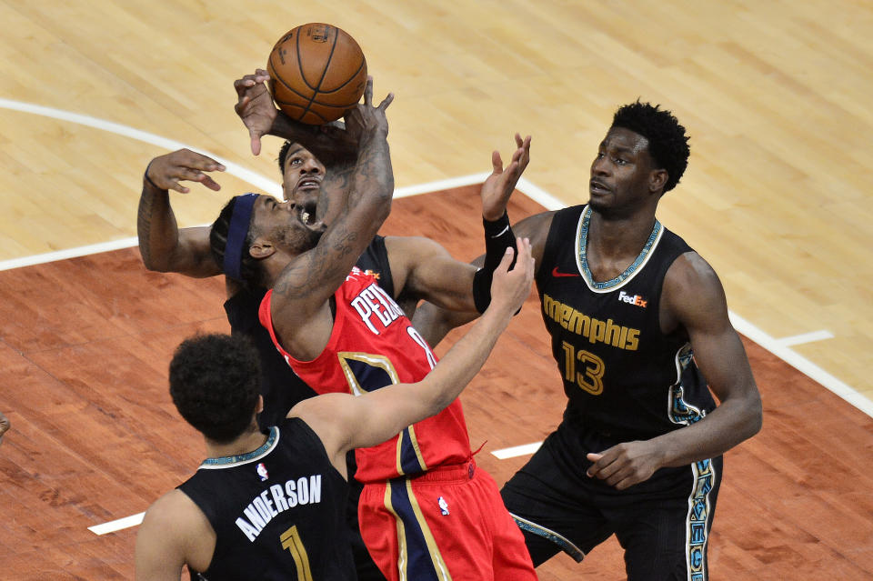 New Orleans Pelicans forward Naji Marshall (8) struggles for control of the ball between Memphis Grizzlies forwards Jaren Jackson Jr., (13), Kyle Anderson (1), and center Xavier Tillman in the second half of an NBA basketball game Monday, May 10, 2021, in Memphis, Tenn. (AP Photo/Brandon Dill)